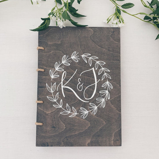 Grey unique wooden guestbook with kraft jute. Decorated with personalised Calligraphy initials and floral illustration
