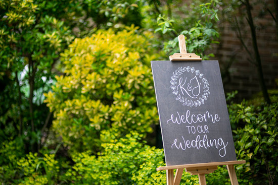 Wooden welcome sign in grey with hand painted white calligraphy