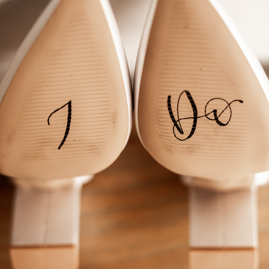 Wedding shoes painted with I Do on the bottom for Bride