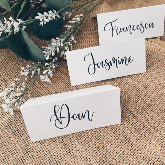 White textured paper place cards with black brush calligraphy names for Kent wedding