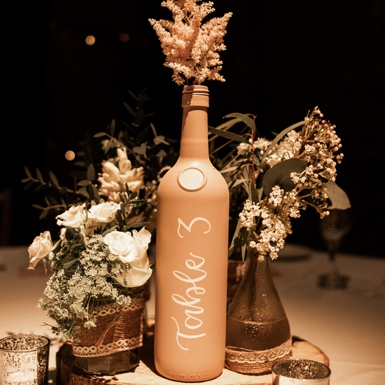Wedding table number using wine bottle, hand painted with white calligraphy at Kent wedding venue