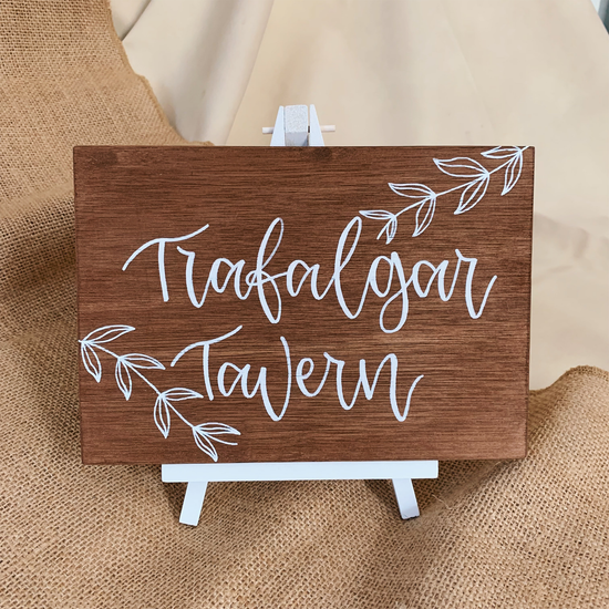 A5 wedding table number sign made from brown stained wood and painted in white calligraphy